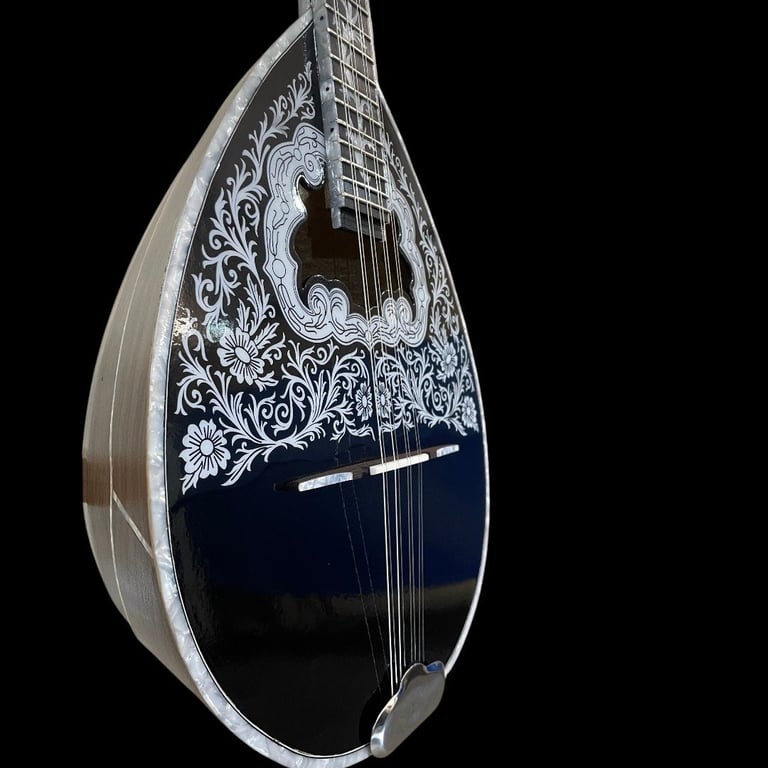 Ornate mandolin with teardrop-shaped body, intricate white floral inlay on dark blue soundboard, and fretted fingerboard against black background