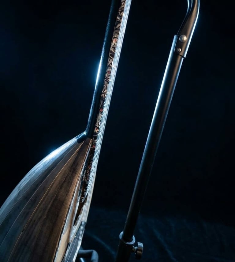 Close-up of two flute instruments against a dark background, showing metallic keys and tonehole details