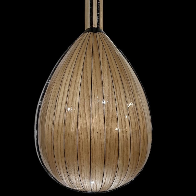 Teardrop-shaped pendant light with tan ribbed wooden exterior and metal top fixture against black background