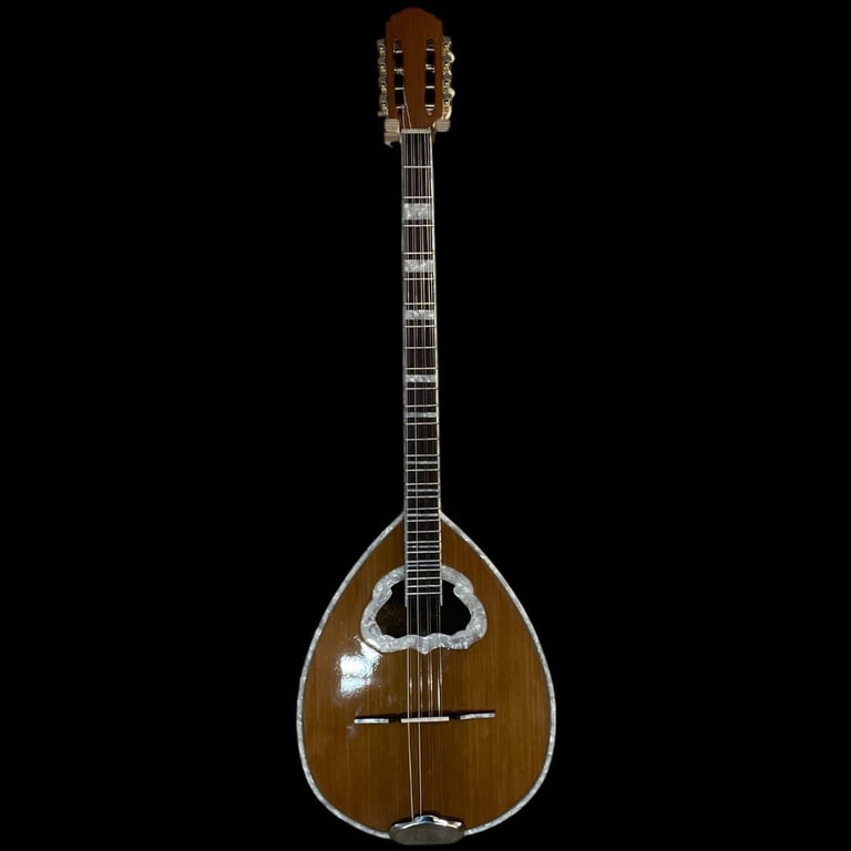 Brown wooden mandolin with teardrop-shaped body, long neck with frets, and tuning pegs against black background