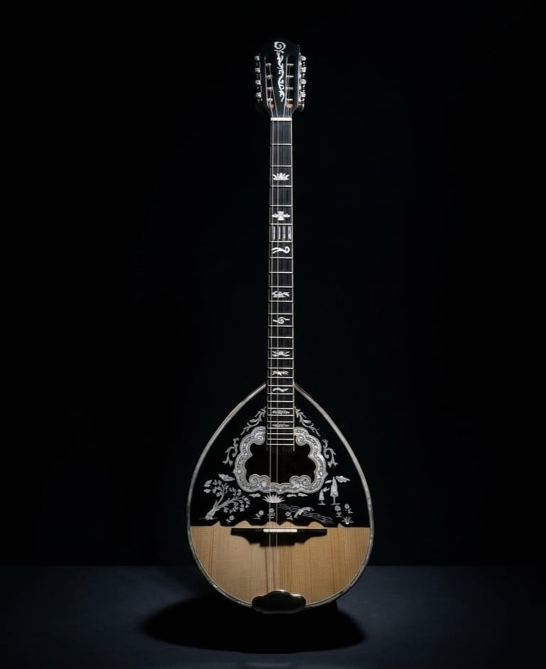 Greek mandolin with ornate inlaid black pickguard and wooden body against black background