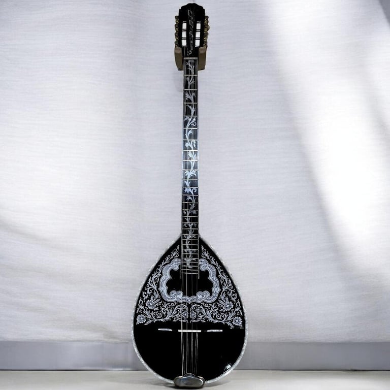 Black mandolin with ornate white floral inlay design on pear-shaped body and long fretted neck